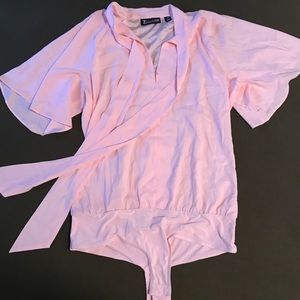 Pink top, body suit fit. (Onesie fit)